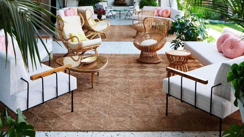 Luxurious patio with stylish furniture and large geometric outdoor rugs.
