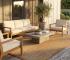 Stylish patio with teak furniture centered on a natural fiber outdoor rug.